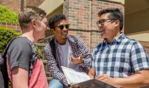 HSU students smiling and talking outside on campus